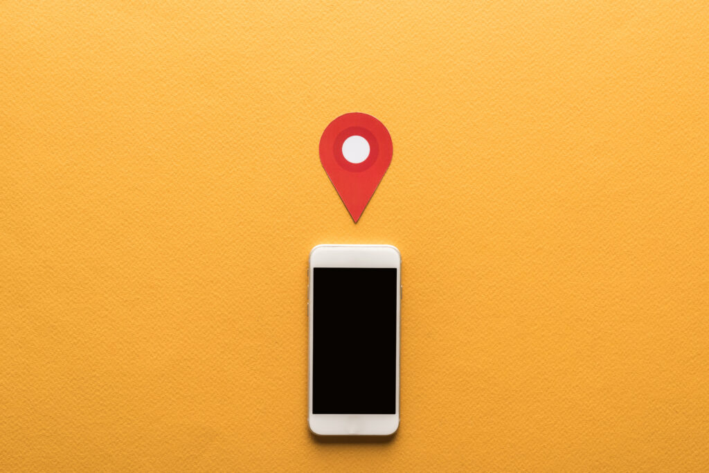 Google My Business optimisation shown by a smartphone and red map pin